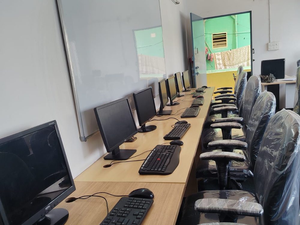 The training room seen down the length of the bench, monitors on the left and chairs on the right.